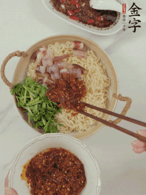 在面上鋪魷魚(yú)、香菜、金字火腿大師醬。